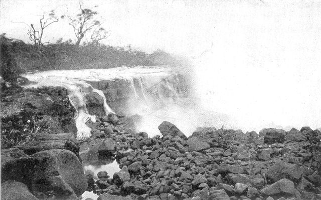 Lava stream, in Hawaiian Islands, flowing into the
sea. Note the "ropy" character of the half-frozen rock on the sides of
the nearest rivulet of the lava.