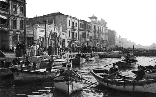 “On one side of the quay, a moving-picture palace, ... on
the other a boat unloading fish.”